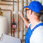 Engineer controlling the heating pipes at the boiler room